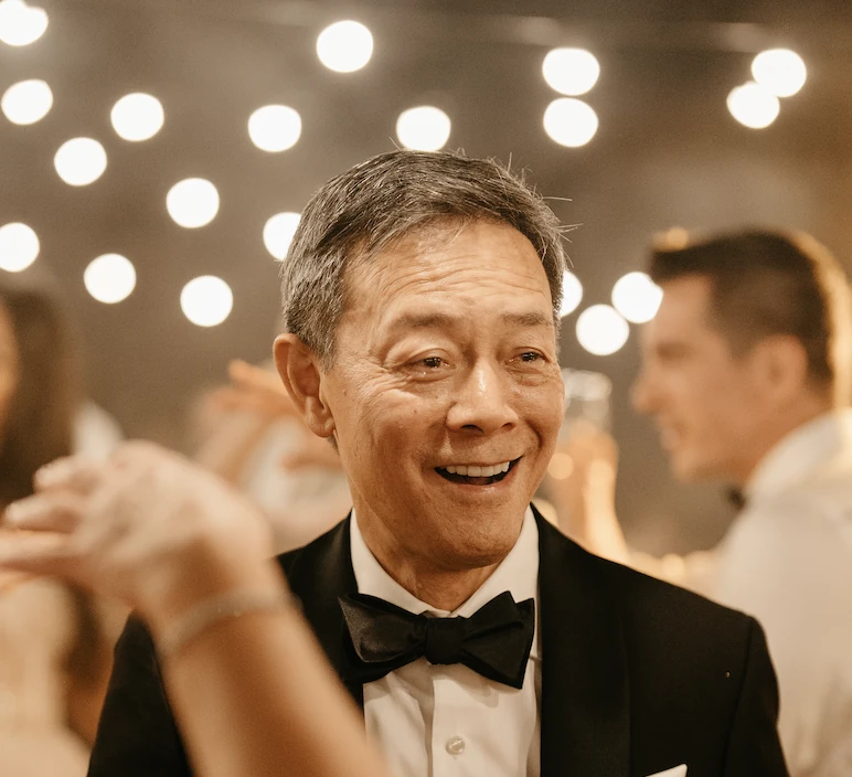 Ben Wong smiling in a tuxedo at a celebration